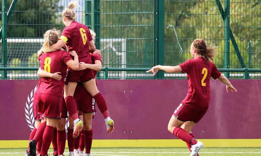 Cardiff Met Women team celebrate scoring a goal during a match