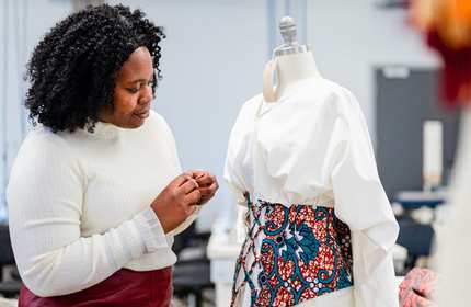 Student views a piece of clothing on a modelling dummy