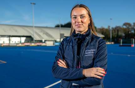 Liberty Andrews stand with arms folded on a playing pitch on the Cardiff Met Cyncoed Campus