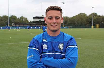 Scott Wickens stands with arms folded while standing on a football pitch
