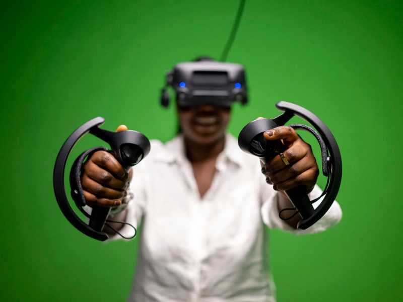 Student wearing virtual headset and holding controllers