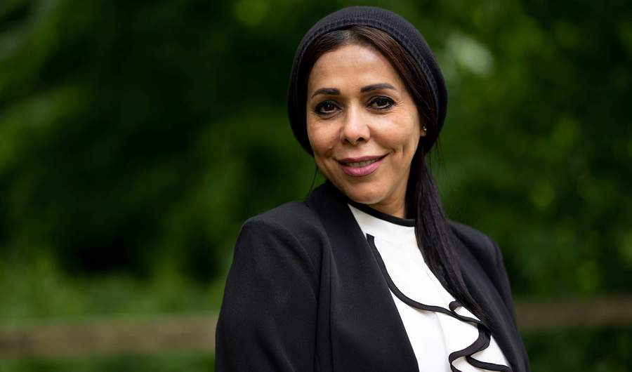 A person wearing a headscarf and dark jacket