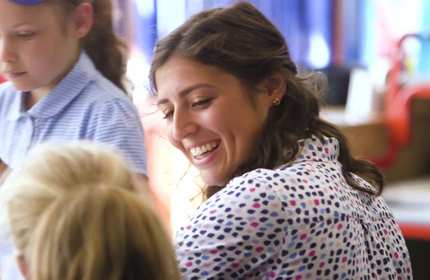 Teacher smiles at pupil