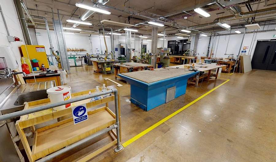 Wide view of workshop floor including tables and safety equipment