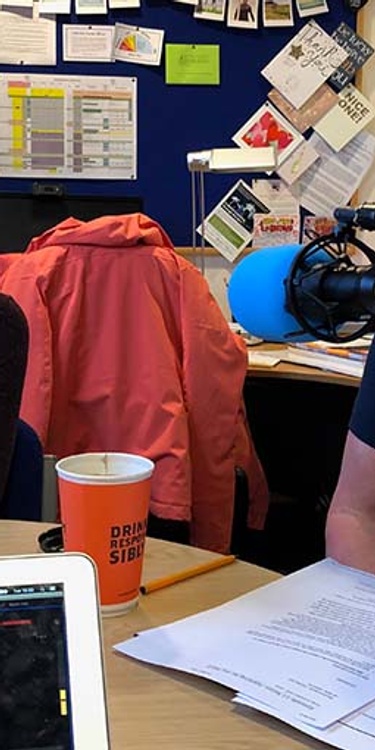 Lecturers sat in front of microphones at a round table in discussion