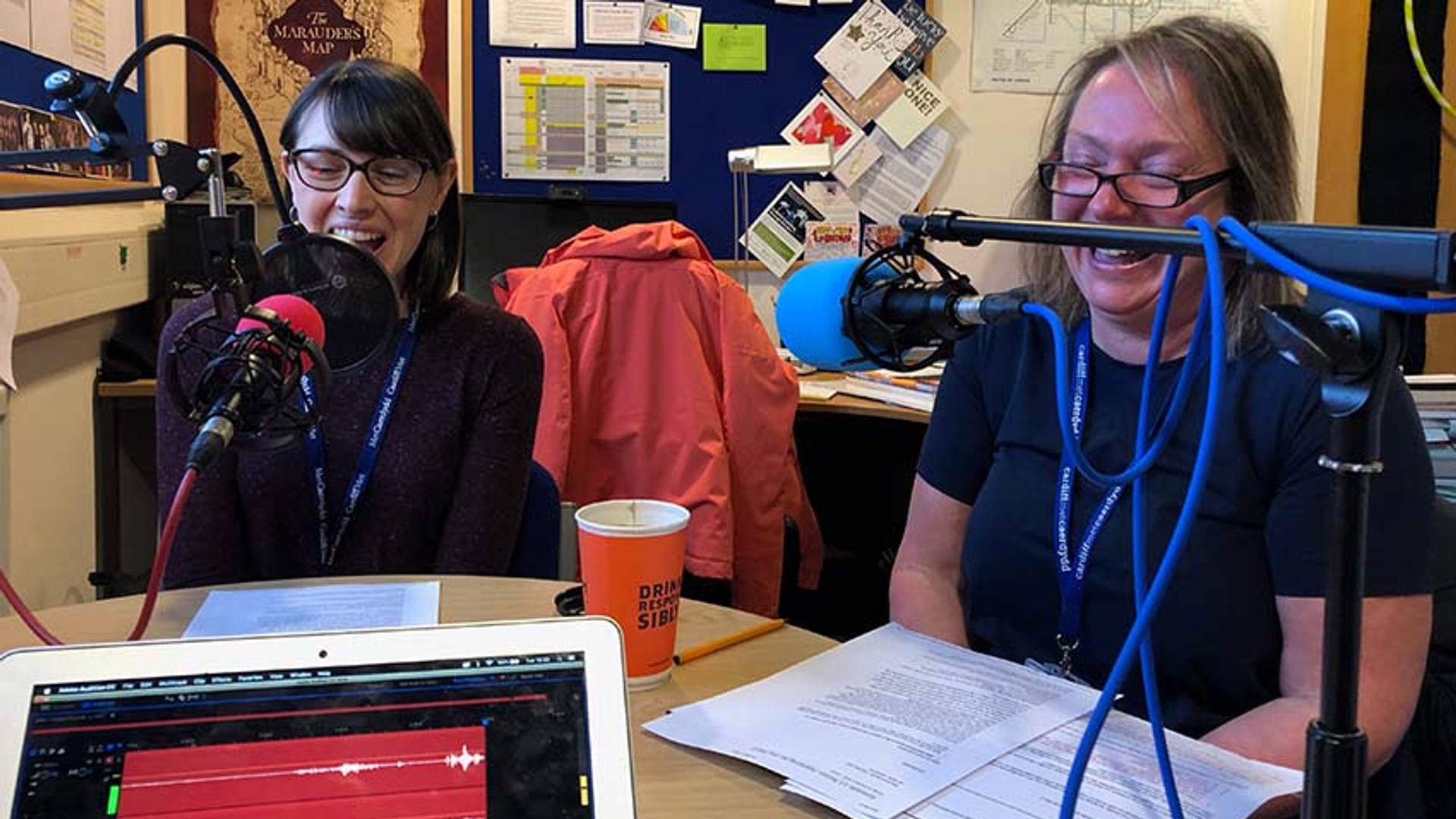 Lecturers sat in front of microphones at a round table in discussion