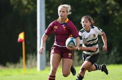 A Cardiff Metropolitan University rugby player runs with the ball during a game