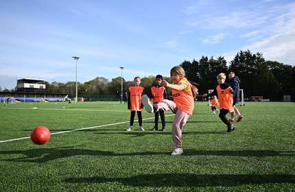School children play football during a Cardiff Met Open Campus event