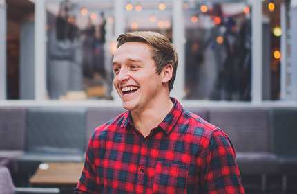 Bradley Woolridge smiling in seating area